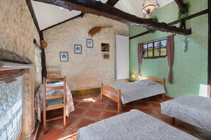A rustic room with two wooden beds, a small table, and a chair. - Bed and Breakfast 'Chambre - L'herbier' with Shared Terrace, Shared Garden and Wi-Fi (Castillon)