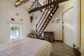 A bedroom with a bed, a wooden ladder, a desk, and a chair. - Bed and Breakfast 'Chambre - La Campagne' with Shared Terrace, Shared Garden and Wi-Fi (Castillon)
