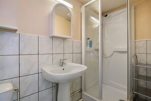 A bathroom with a white sink, a glass shower enclosure, and a mirror above the sink. - Bed and Breakfast 'Chambre - La Campagne' with Shared Terrace, Shared Garden and Wi-Fi (Castillon)