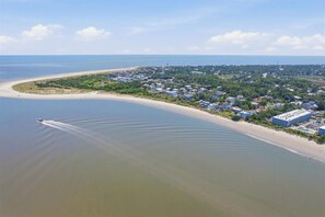 An aerial view of a coastal town with a beach, houses, and a large hotel. - Ocean-View North Beach Condo with Pools & Community Private Beach Access (Tybee Island)