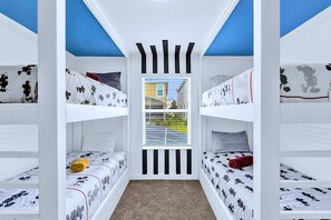A bunk bed room with a window and a view of a building outside. - Disney Area Villa w Private Pool & Resort Access (Davenport)
