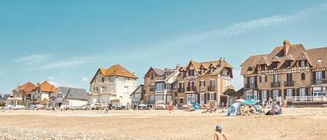 A beach with buildings in the background.