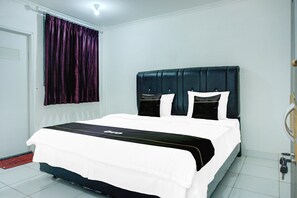 A hotel room with a bed, a window with curtains, a door, and a tiled floor. - Stylish DBL Suite Escape W/ Free Wifi and Parking (Bandar Lampung)