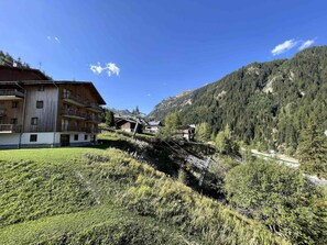 A mountain lodge with multiple balconies, a ski lift, and a forested backdrop. - Pleasant apartment, pets allowed - 6 guests (Valfréjus)