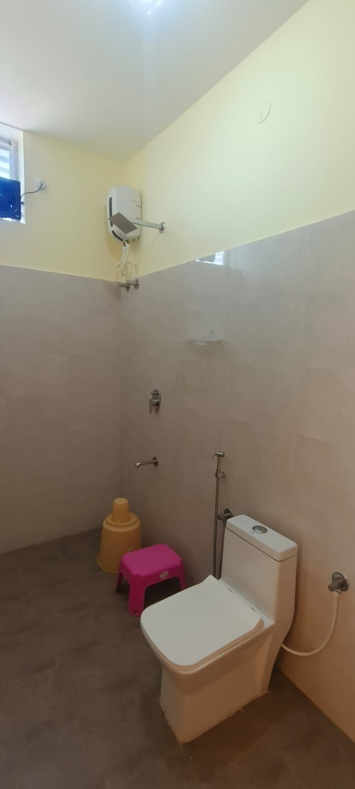 A small bathroom with a toilet, a shower, and a sink.