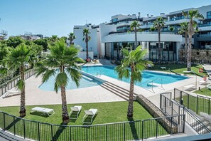 A modern hotel with a swimming pool, palm trees, and a view of the city. - LME81B - Sea view terrace - indoor pool (Estepona)