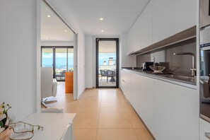 A modern kitchen with a view to the outside. - LME81B - Sea view terrace - indoor pool (Estepona)