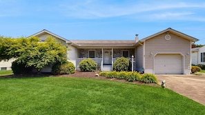 A two-story house with a front porch, a garage, and a well-maintained lawn. - Keen-Wik on the Bay - 38351 Walnut Ln (Selbyville)