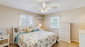A bedroom with a bed, a nightstand, a dresser, and a ceiling fan. - Keen-Wik on the Bay - 38351 Walnut Ln (Selbyville)