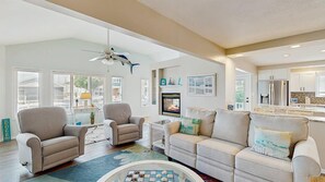 A spacious living room with two sofas, a coffee table, and a fireplace. - Keen-Wik on the Bay - 38351 Walnut Ln (Selbyville)