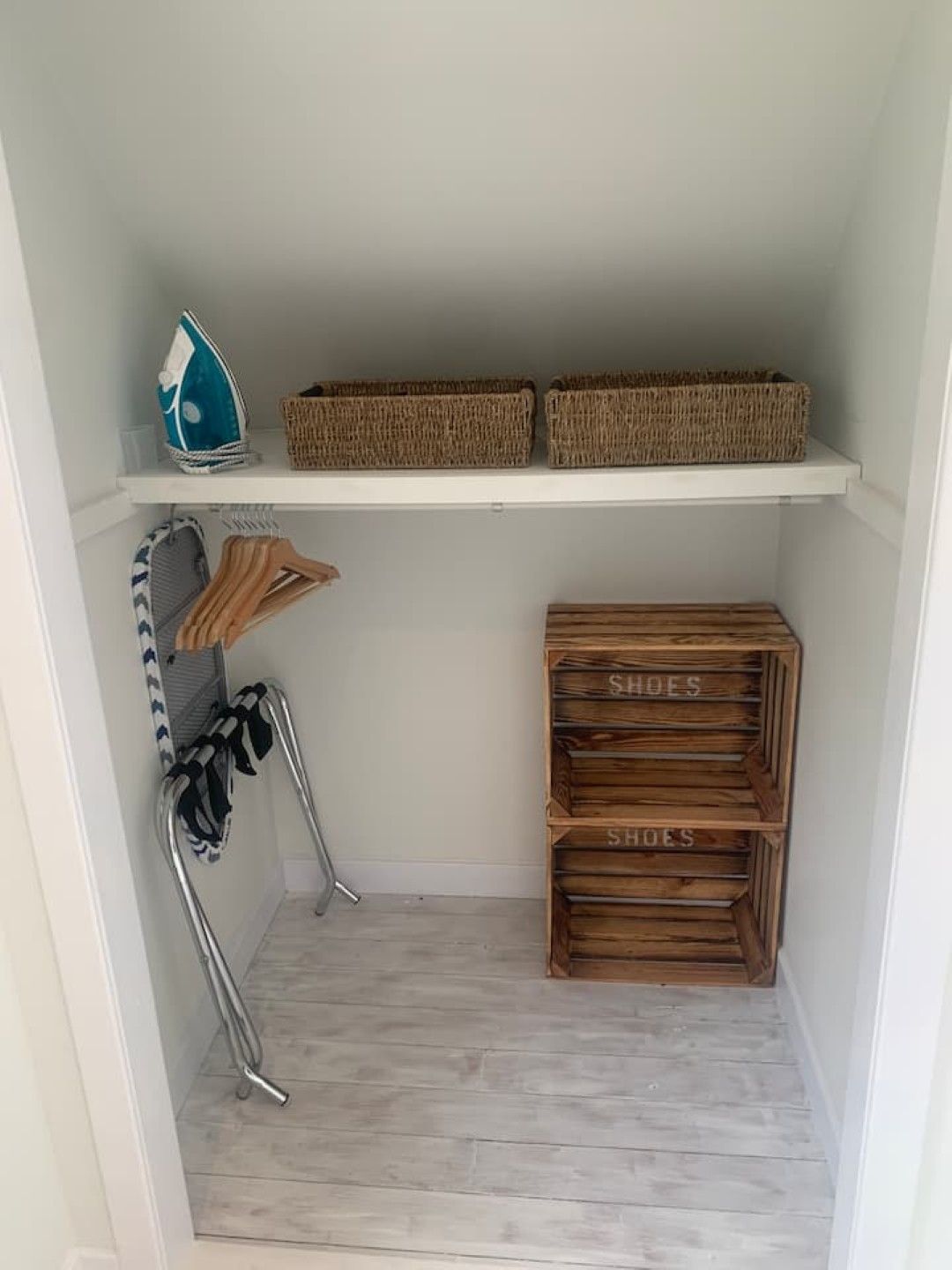 A storage area with shelves, baskets, and shoe storage.