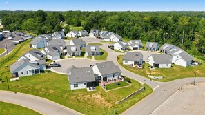 A residential area with houses arranged in a circular pattern around a central road.