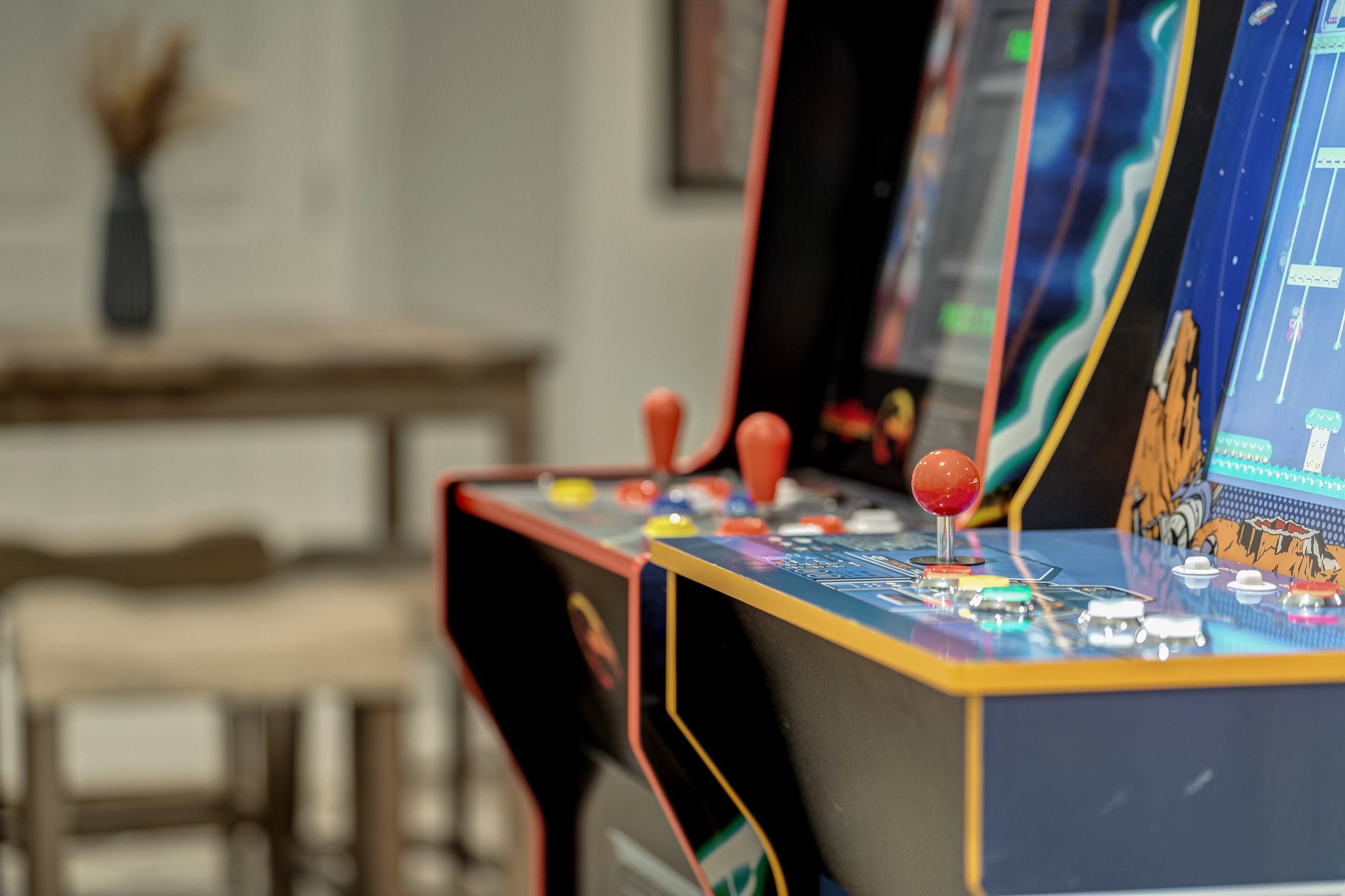 A close-up of a vintage arcade machine with colorful buttons and joysticks.