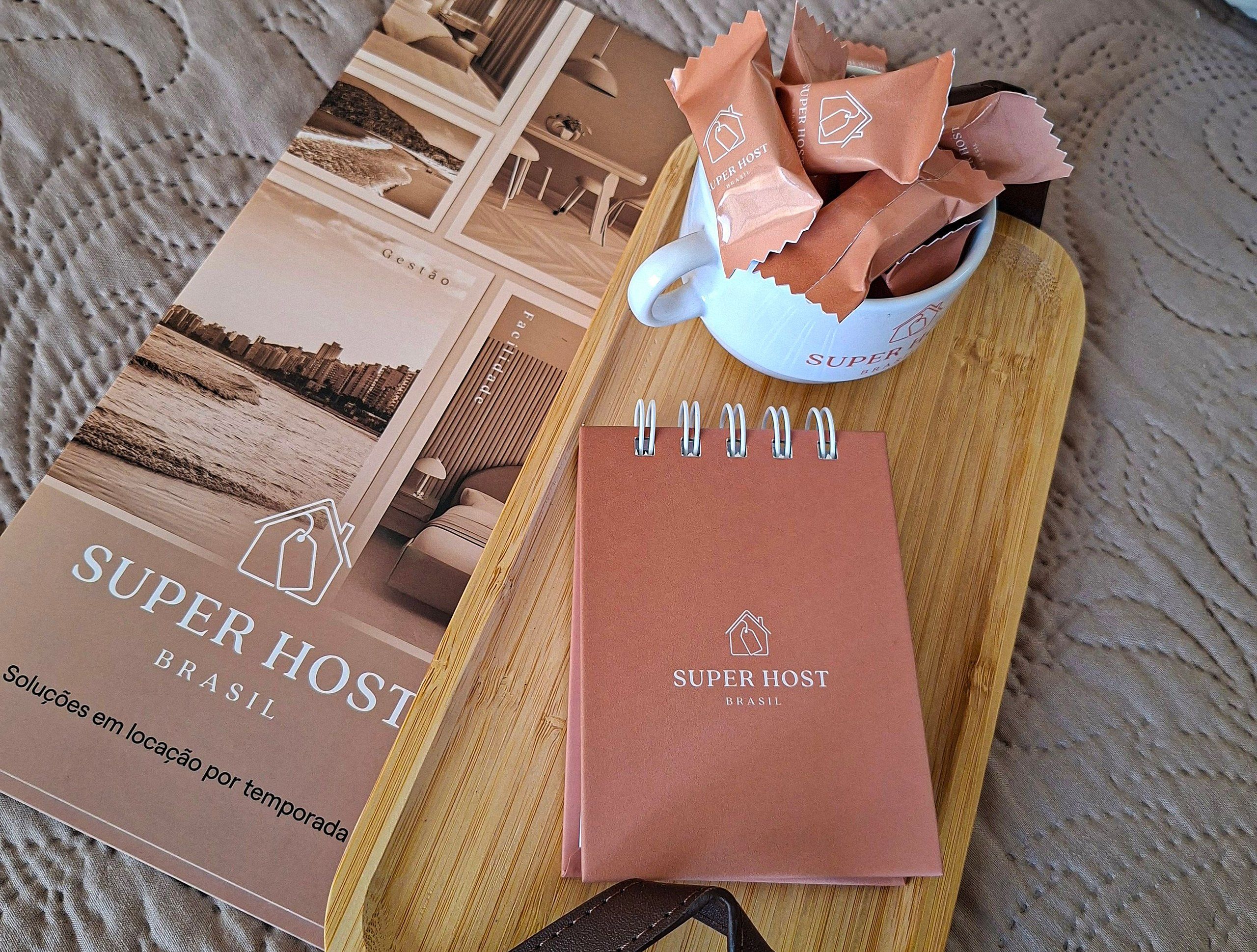 A notebook, a tray with a notebook, and a bowl of cookies.