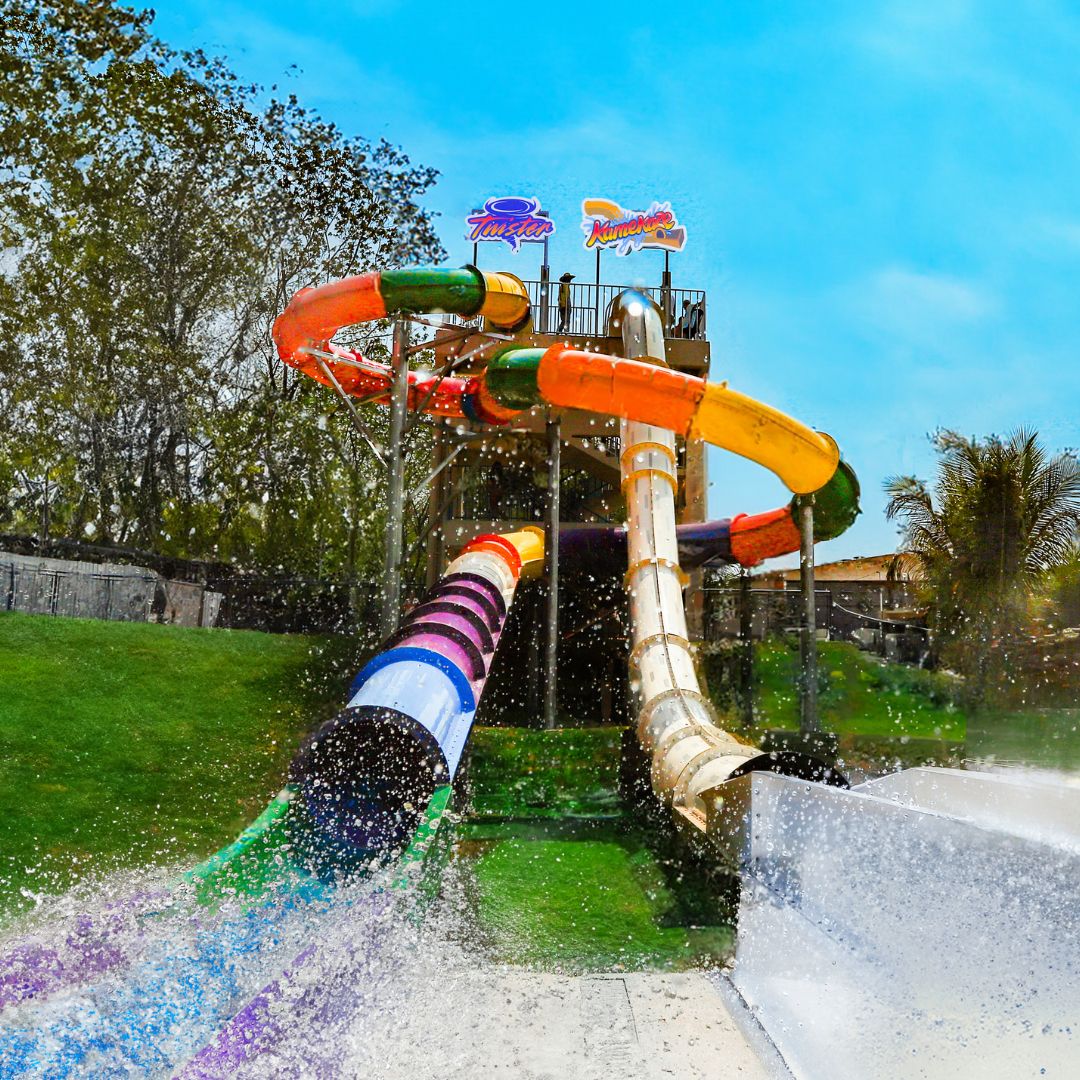 A water slide with multiple lanes and a clear sky in the background.