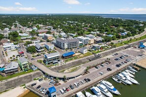 An aerial view of a coastal town with a marina, roads, and buildings. - BEACH TIME TOO
Incredible 3-bedroom condo  in the heart of Bay St Louis (Bay St Louis)
