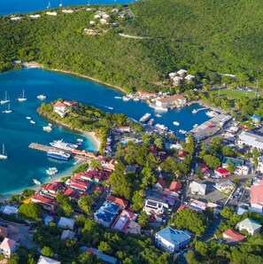 An aerial view of a coastal town with a marina, houses, and lush greenery. - A3 Sea Urchin (Cruz Bay)