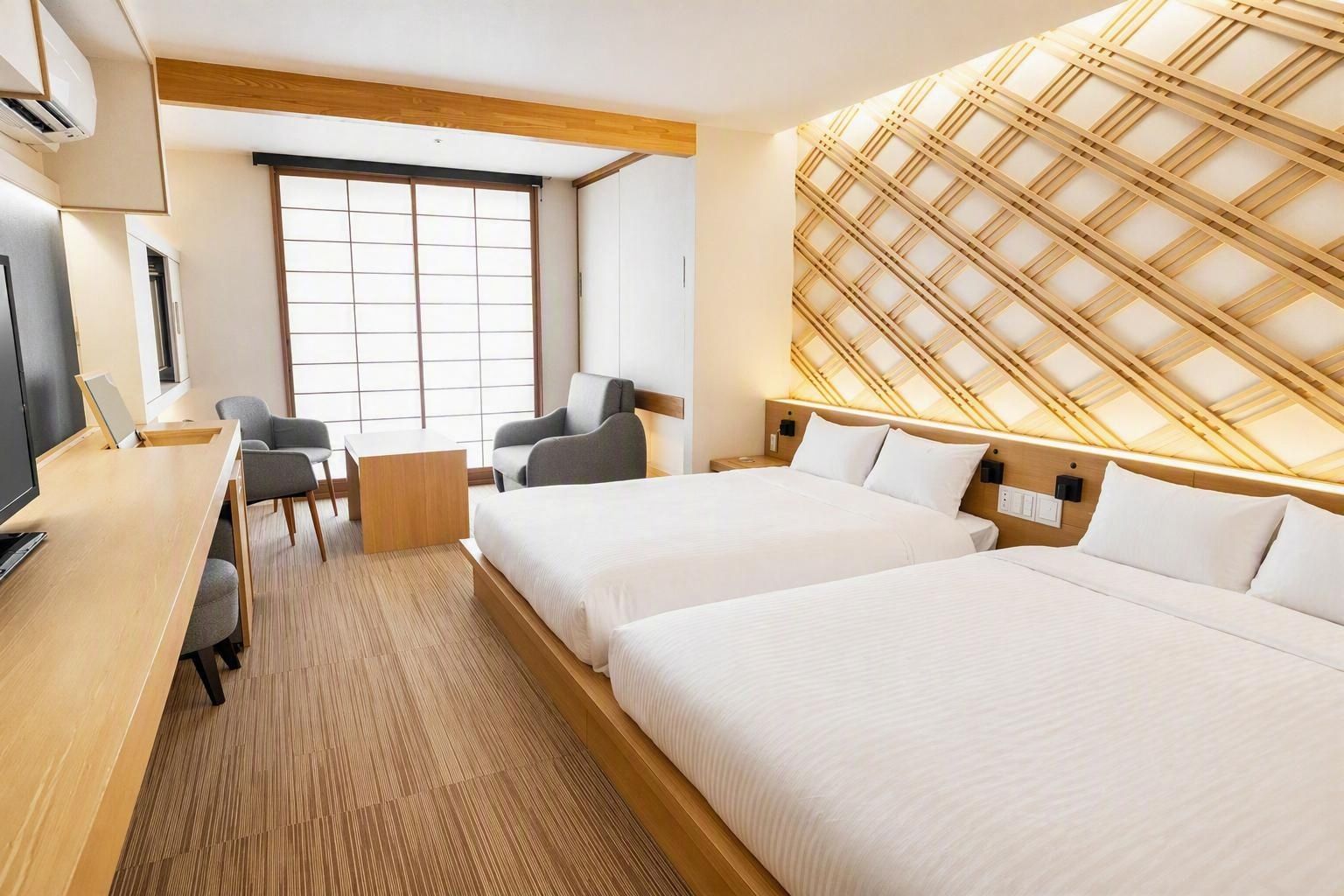 A hotel room with two beds, a desk, a chair, and a large window.