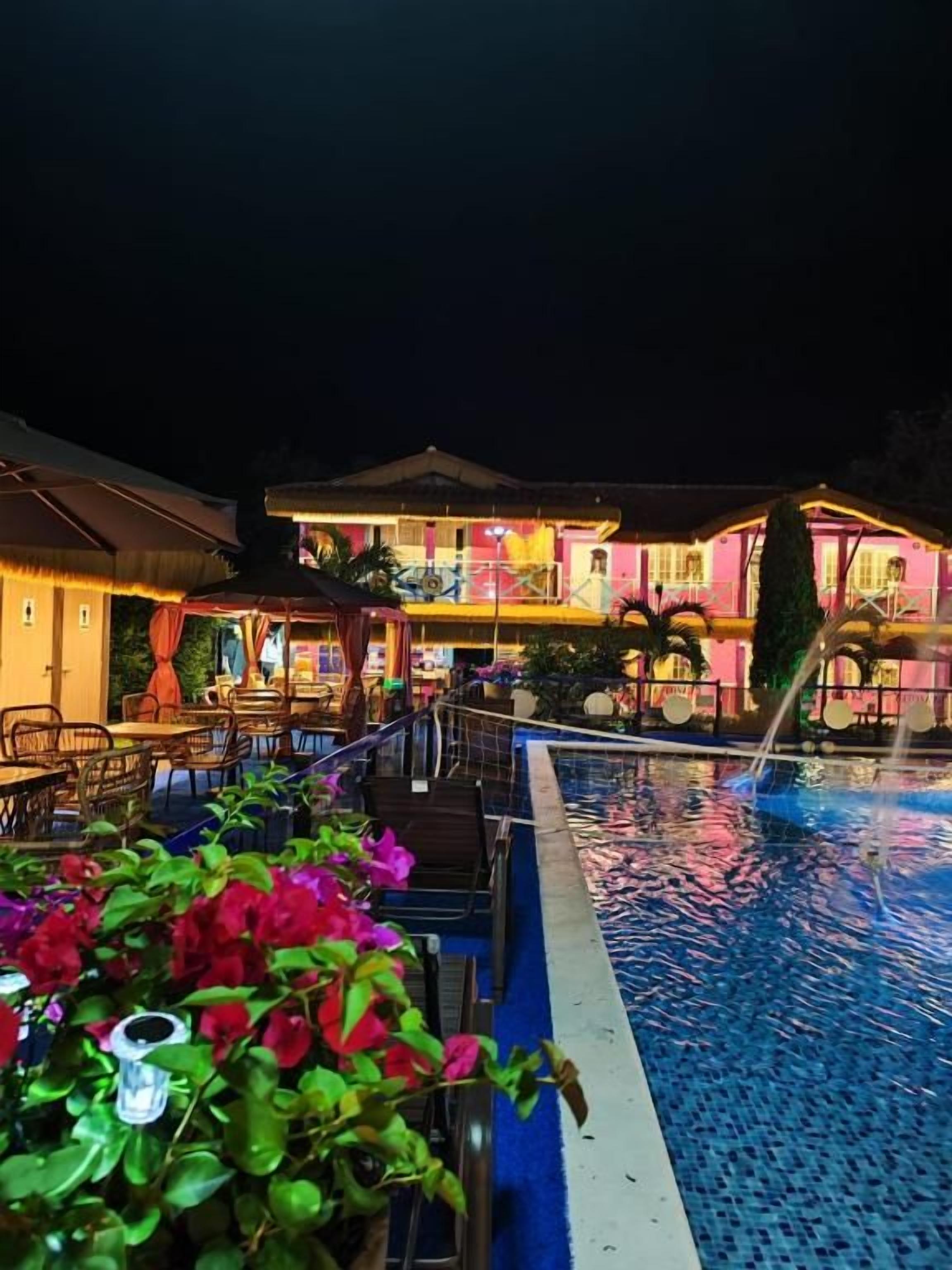 A swimming pool area with a building in the background.