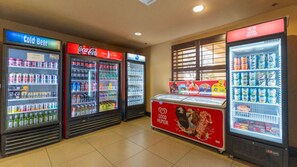 A vending area with various beverage options including cold beer and Coca-Cola. - Harry Potter Apartment Near Universal (Orlando)