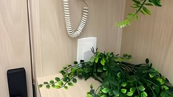 A wooden door with a white telephone and a power outlet.