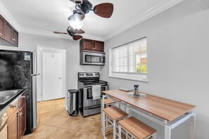 A kitchen with a refrigerator, stove, microwave, and a ceiling fan. - Spacious 3BR Seaside Park Getaway Near the Beach (Seaside Park)