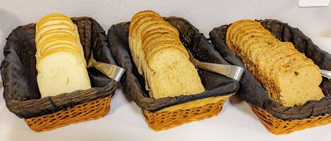 Three wicker baskets containing sliced bread.