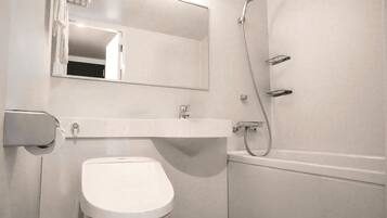 A bathroom with a toilet, sink, and shower.