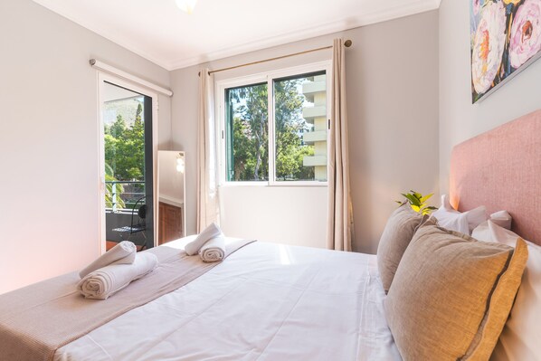 A hotel room with a bed, a window with curtains, a chair, and a plant. - Musa d Ajuda by Atlantic Holiday (Funchal)