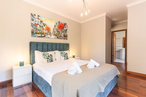 A hotel room with a bed, nightstands, a painting, and a view of the bathroom. - Musa d Ajuda by Atlantic Holiday (Funchal)