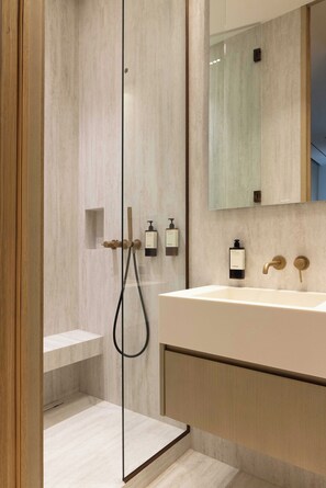 A modern bathroom with a glass-enclosed shower, a large sink, and a mirror above it. - Luxurious Suite - AC- 2P- Madeleine/saint Honore (Paris)