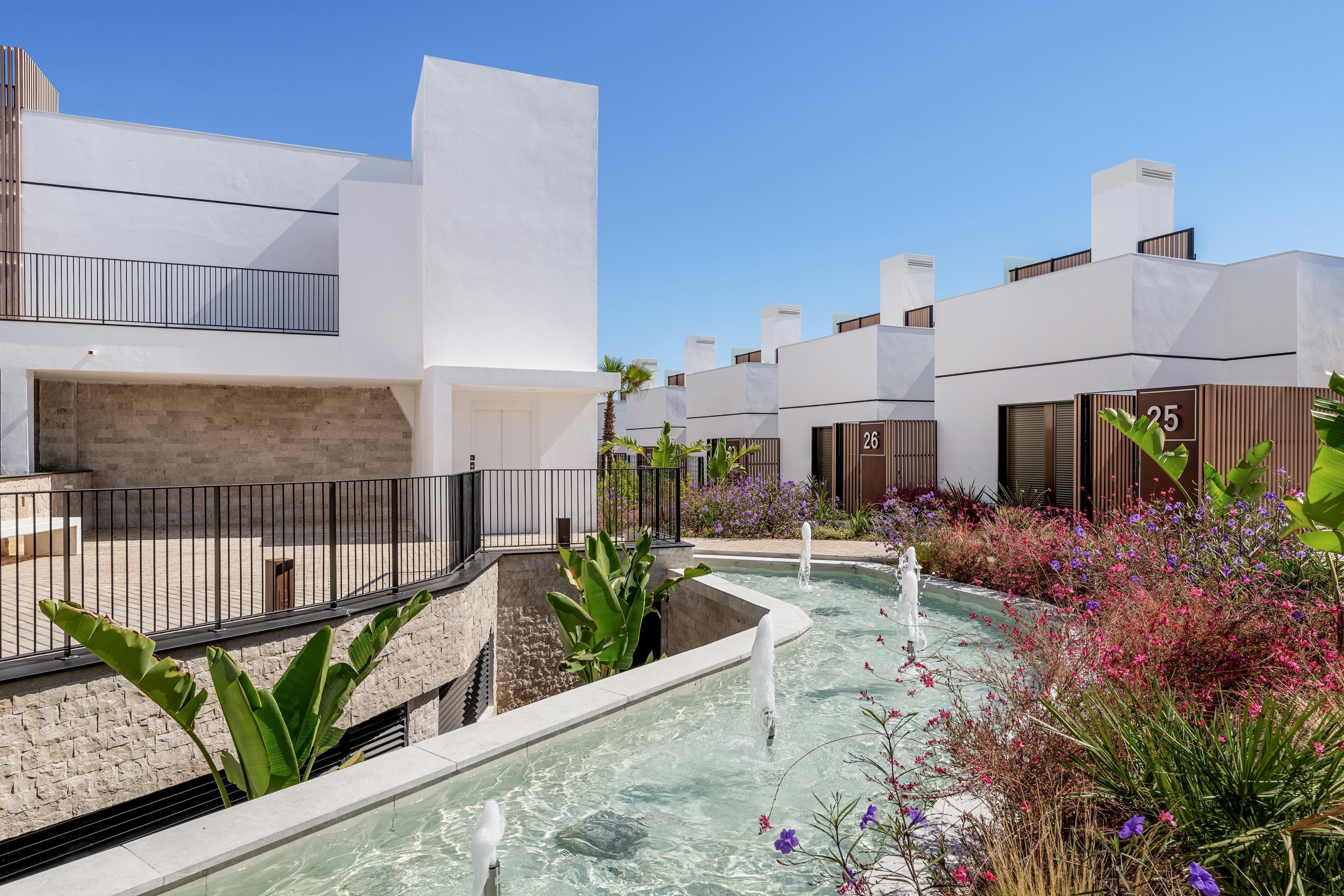 A modern building with a pool and a garden.