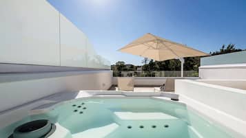 A hot tub with a view of the surrounding area.