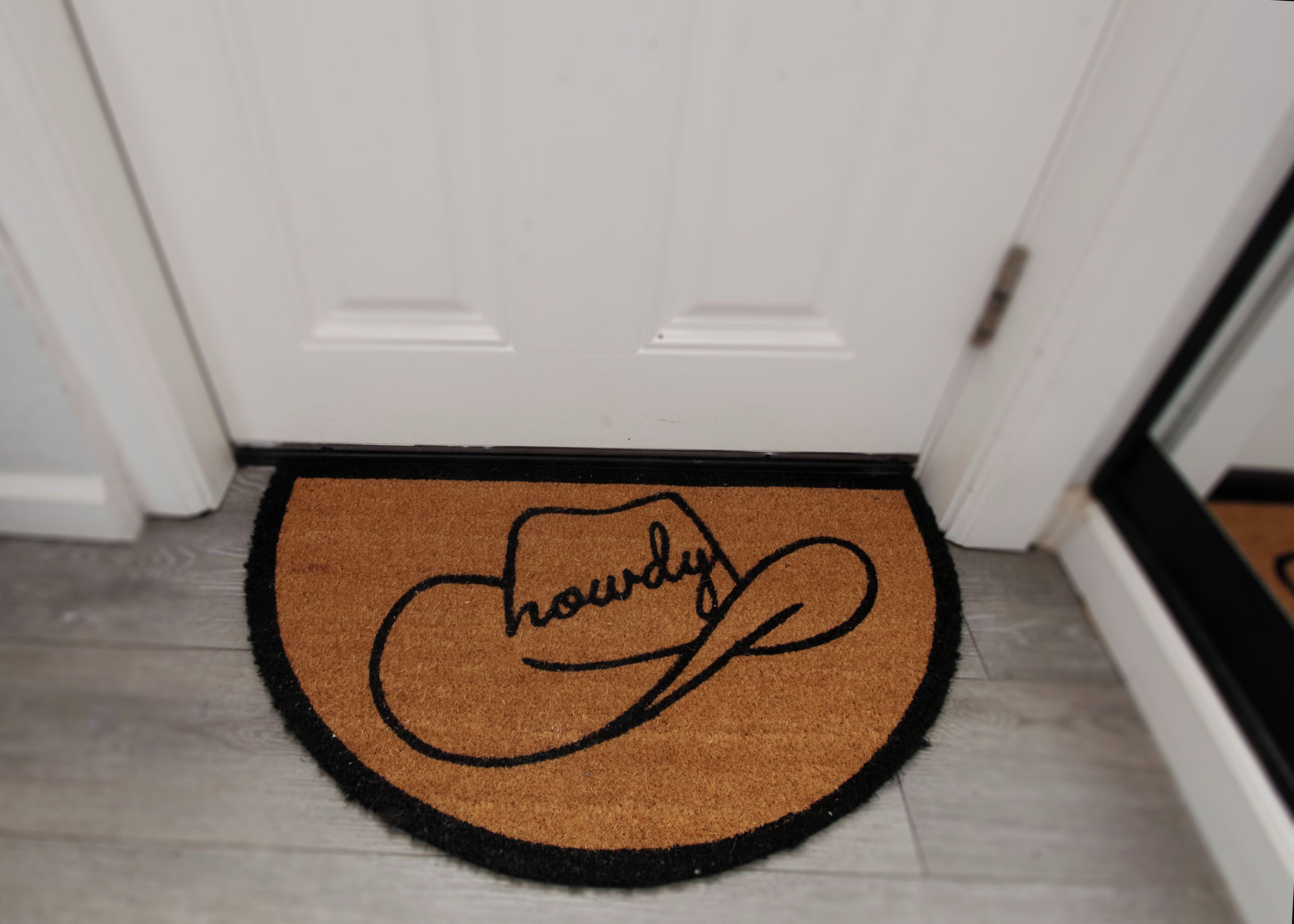 A doormat with the word 'hourly' written on it.