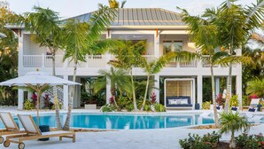 A modern two-story house with a swimming pool, outdoor seating, and tropical landscaping. - Albury Landing in Tavernier (Tavernier)