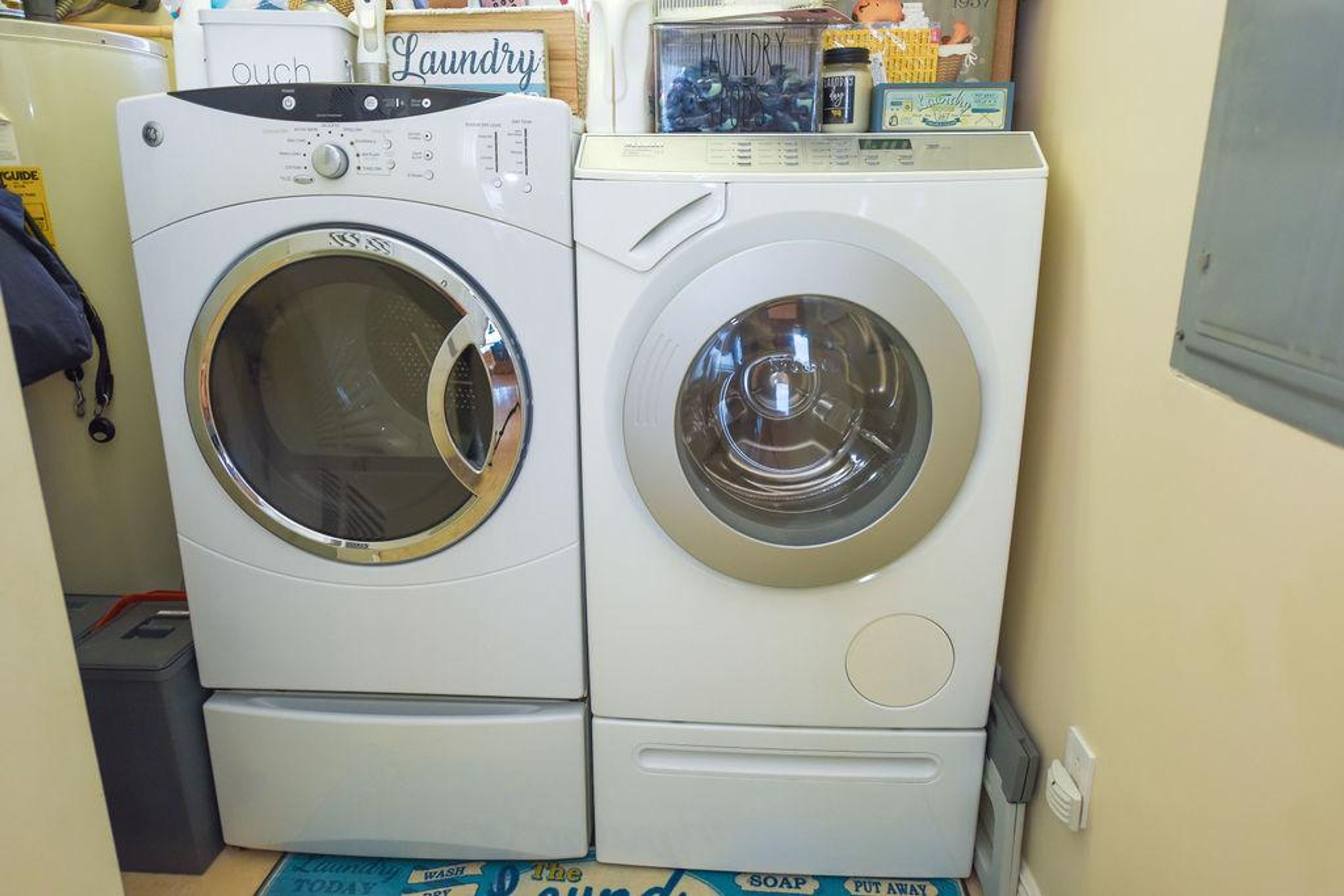 Two front-loading washing machines in a laundry room.