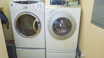 Two front-loading washing machines in a laundry room.