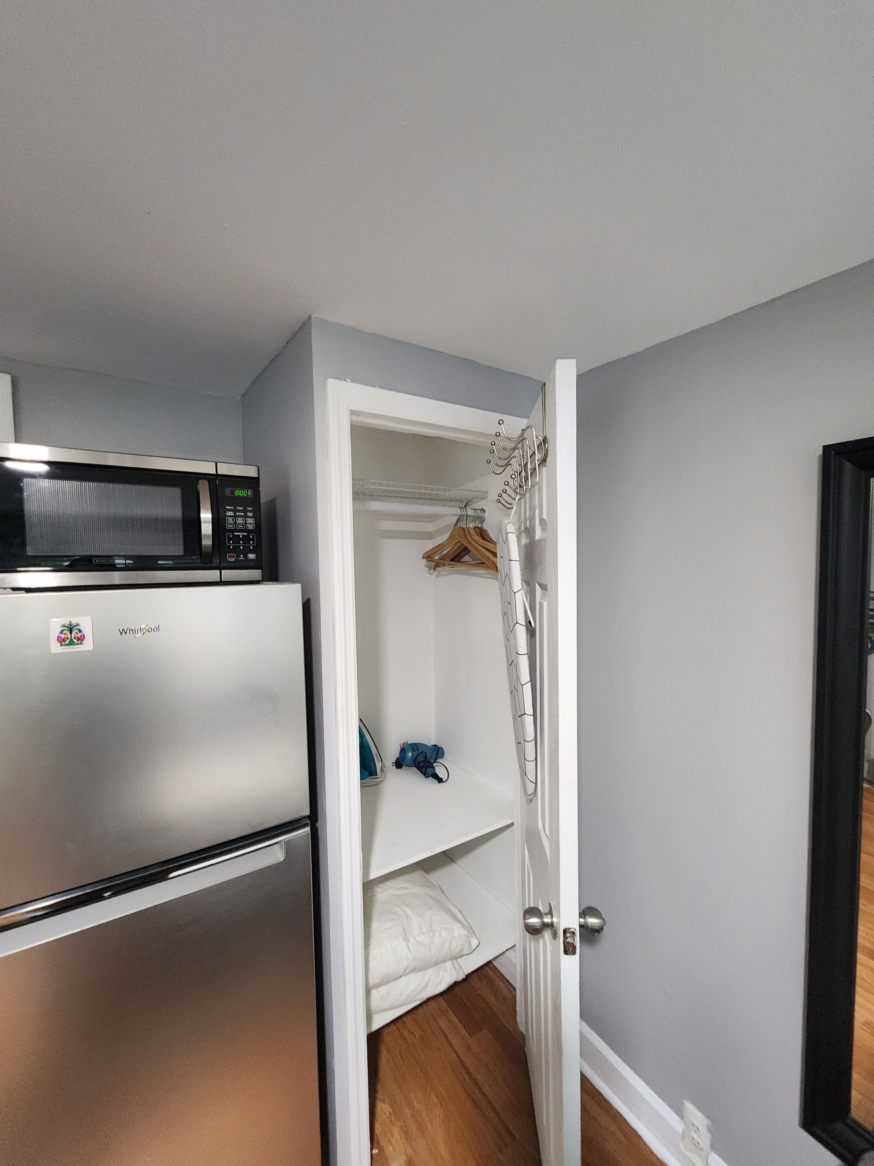 A compact kitchen with a microwave and a refrigerator.