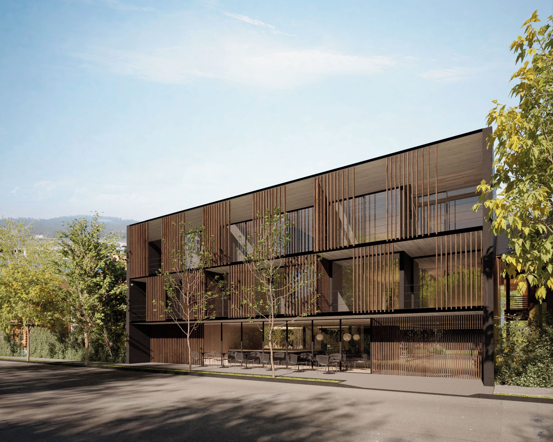 Un bâtiment moderne doté d’un toit plat, de grandes fenêtres et d’une série de lamelles de bois verticales.
