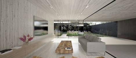 A modern interior with a wooden floor, a sofa, a coffee table, and a large window overlooking a garden.