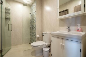 A bathroom with a toilet, sink, and shower. - Walk to Nai Yang Beach! Stylish 7th-Floor 1BR Apt 711 - Pool, Gym, Near Airport (Tambon Sa Khu)