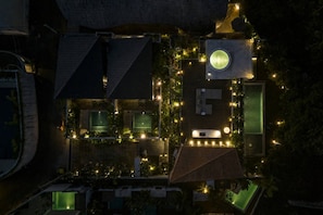 An aerial view of a residential property with multiple rooms, a circular skylight, and outdoor lighting. - KINOH Loft II Private Pool & Tropical Design (South Kuta)