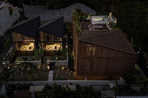 A modern villa with a rooftop pool, a hot tub, and a well-lit outdoor seating area surrounded by tropical plants. - KINOH Loft II Private Pool & Tropical Design (South Kuta)