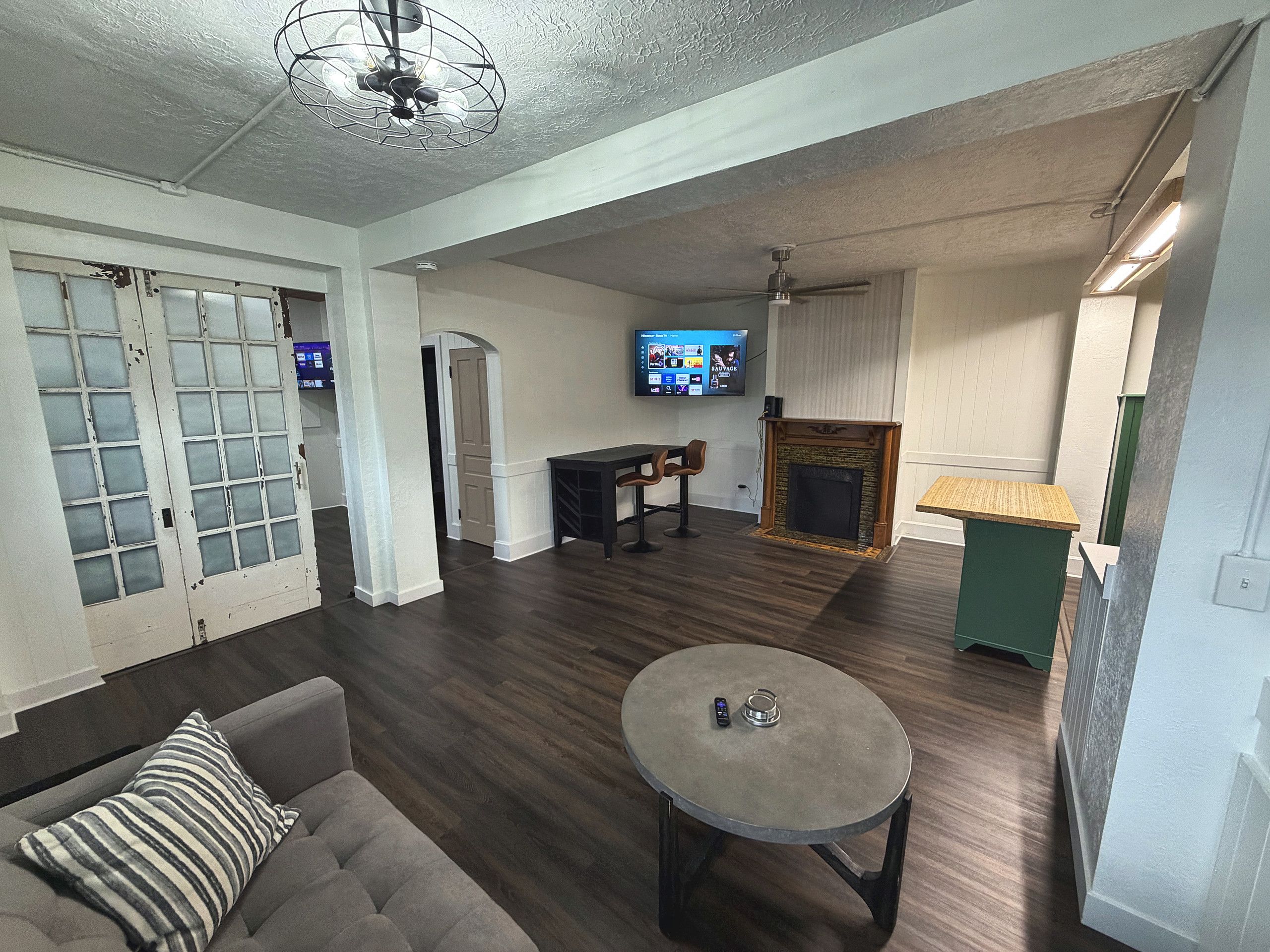 A living room with a fireplace, a television, and a sofa.