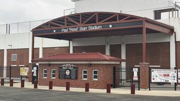 A stadium entrance with a sign for Paul 'Hoss' Stall Stadium.