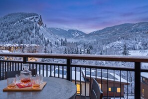 A snow-covered mountain landscape with a view of a building with multiple windows and a balcony. - Beaver Creek Penthouse - Luxe Amenities&Mtn Views (Avon)