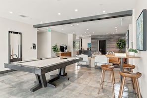 A pool table in a modern lounge area with a bar and seating. - Beaver Creek Penthouse - Luxe Amenities&Mtn Views (Avon)