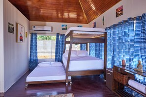 A bunk bed room with a wooden ceiling, a window with curtains, and a small table with a statue. - Surfers Paradise Villa, front row seats to the most breathtaking beach sunsets. (Mt. Irvine)