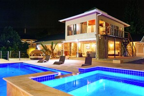 A two-story house with a swimming pool and outdoor seating. - Surfers Paradise Villa, front row seats to the most breathtaking beach sunsets. (Mt. Irvine)