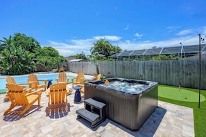 A backyard with a hot tub, outdoor seating, and a swimming pool. - Sports Court • Putt Putt • Gym • Pool • Hot Tub (Bradenton)